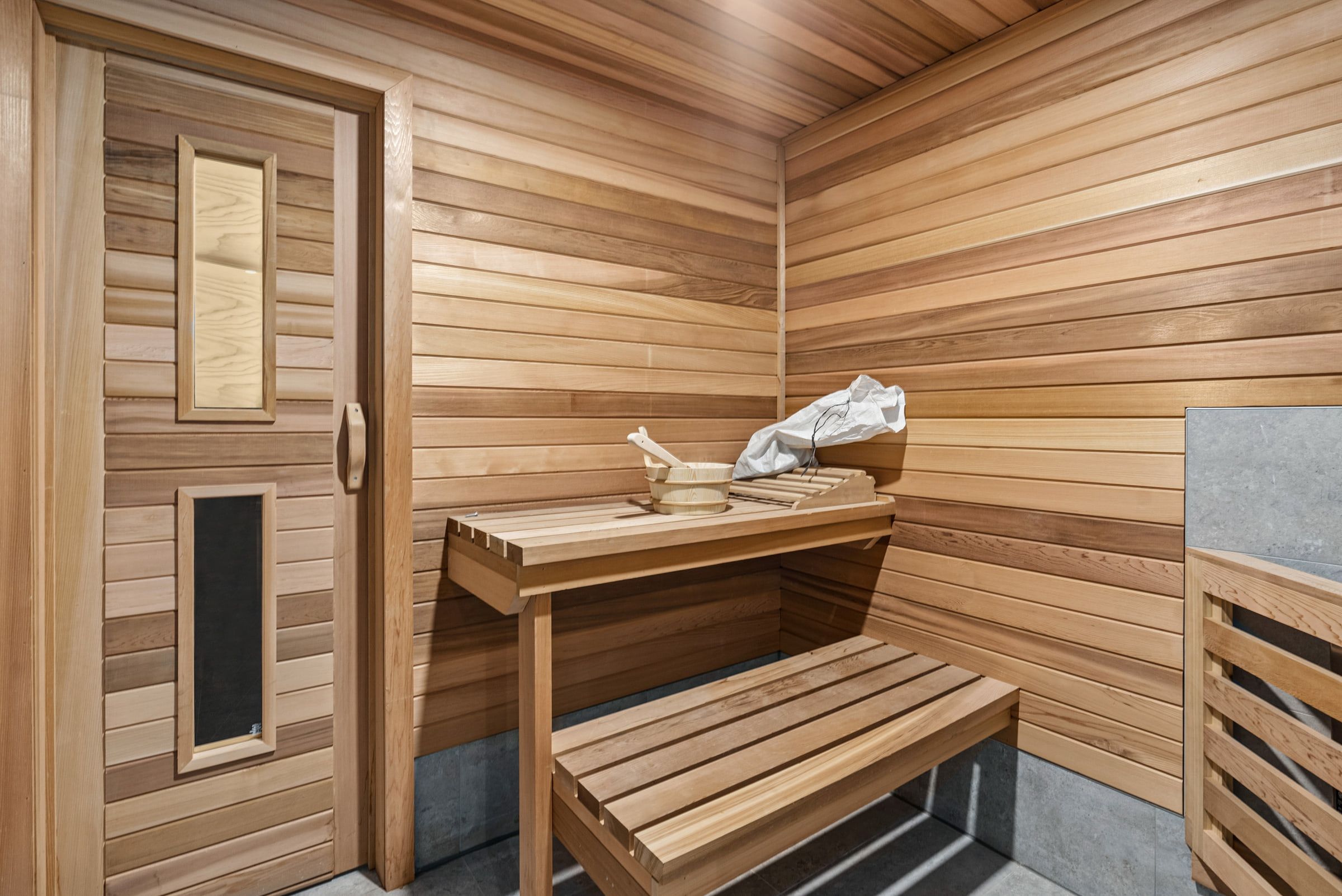 Cedar-lined sauna with wooden benches.